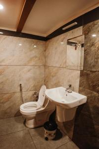 a bathroom with a toilet and a sink at Venice Premium Houseboats Alleppey in Alleppey