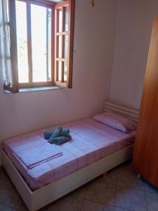 a bed in a room with a window at Traditional Stone House in Moudhros