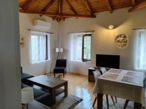 a living room with a couch and a table at Vaki's country house in Pylos