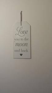 a sign that says love you to the moon and back at Studio Apartment Kala in Split