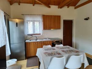 a kitchen with a table and chairs and a refrigerator at Vaki's country house in Pylos