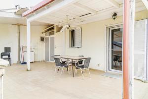 a patio with a table and chairs on it at Gravina suite Apartment in Gravina in Puglia