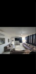 a large living room with couches and a flat screen tv at Chez Sarah in Beni Khiar
