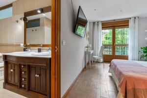 a bathroom with a sink and a bed in a room at Llanes Porrua VVValparon in Porrúa