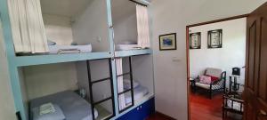 a room with two bunk beds and a hallway at Sojourn Beds & Cafe in Taiping