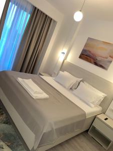 a bedroom with a large bed with a window at Apartament Hera Mamaia Nord in Năvodari +48 photos