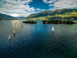 an aerial view of sailboats on a lake with mountains at RELAX Camelia Apartment in Locarno