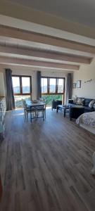 a large living room with a table and a couch at Appartamenti Raggio di Sole in Castel del Monte