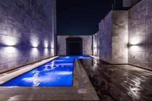 a swimming pool in a building at night at Tura Hotel in Riyadh