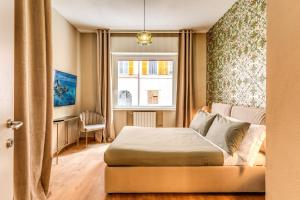 a bedroom with a bed and a window at DOWNTOWN SRL - Croce di Malta Royale in La Spezia