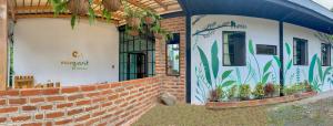a brick building with plants on the side of it at Margarit Boutique Hotel in Mindo