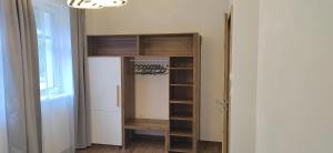 a closet with wooden shelves in a room at Nový apartmán v klidu Jizerek in Smržovka +41 photos