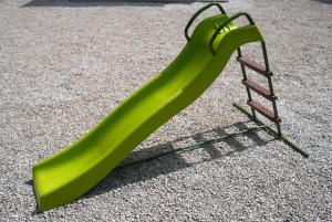 a green slide with a ladder on the ground at Apartment Twins in Šibenik
