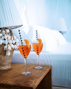 two glasses of orange juice sitting on a table at Simba Wa Kale Suites & Beach in Watamu