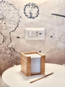 a bathroom with a light switch and a toilet at Il Borgo Boutique Rooms by KasaVacanze in Porto San Paolo