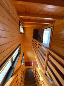 a staircase in a cabin with wood paneling at Natalice By The Sea in Costinesti
