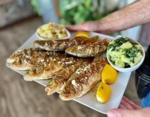 a plate of fish and potatoes and other foods at Apartmani Konoba Starčevo in Virpazar