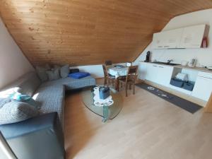 an overhead view of a living room with a table and a kitchen at tAllhouse in Eggolsheim