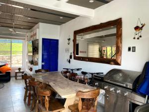 a kitchen with a large wooden table and a mirror at Casa vacacional Carmen de apicala in Carmen de Apicalá