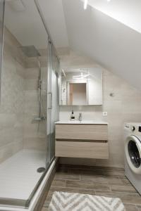 a bathroom with a shower and a sink and a washing machine at Sunshine House in Skala Fourkas +114 photos