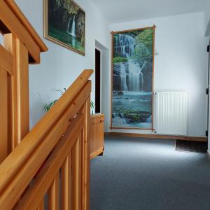 a hallway with a staircase and a waterfall mural on the wall at house Anna in Plitvička Jezera