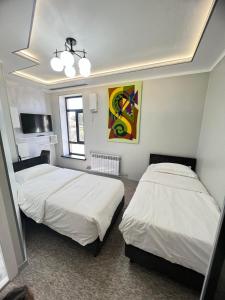 A bed or beds in a room at Mongu Hotel