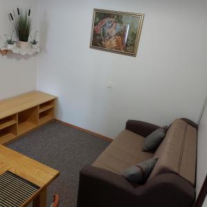 a living room with a brown couch and a table at house Anna in Plitvička Jezera