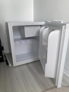 an empty refrigerator with its door open in a room at Single room bentilee in Bucknall