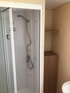a shower in a bathroom with a glass door at Meadow View Horizon Static Caravan in Barnstaple