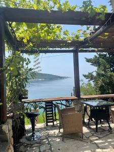 a patio with a table and a view of the water at Guest House Anna in Kruče