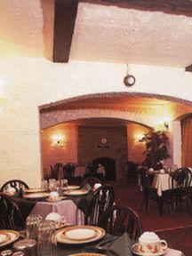 comedor con mesas y sillas y reloj en Victoria Park Hotel, en Mánchester