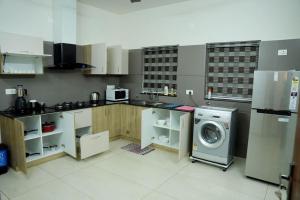 a kitchen with a washer and a washing machine at Crystal Villa Suite2 First Floor in Cochin