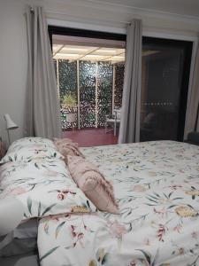 a bed with pillows on it in a bedroom at The Treasure Box in Esperance