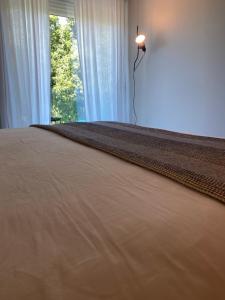 a bedroom with a large bed with a light on it at Hotel Farsund in Sanxenxo