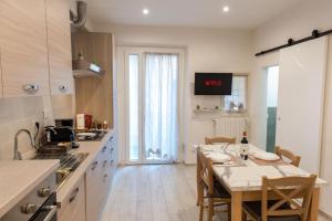 a kitchen with a table and a dining room at Luxury Home Il Giglio in Florence
