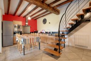 a kitchen with red walls and a table with chairs at Bidainia in Ainhice-Mongelos