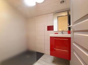 a bathroom with a red cabinet and a mirror at Bidainia in Ainhice-Mongelos +13 photos