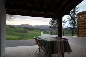 a table and chairs on a patio with a view at Bidainia in Ainhice-Mongelos