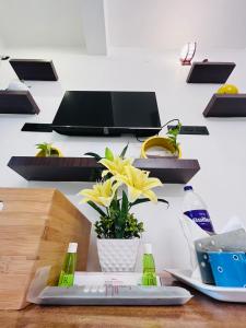 a table with a cutting board and flowers on it at THE LUXE HOTEL in Puducherry