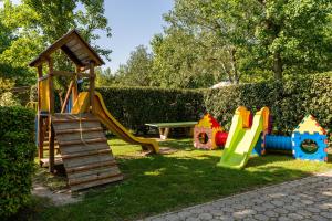 a playground with a slide and a play structure at La Conchiglia in Chioggia