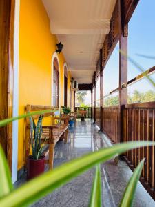 a balcony with benches and tables in a building at THE LUXE HOTEL in Puducherry