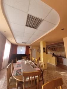 a dining room with a table and chairs at Vila Castelana in Caciulata