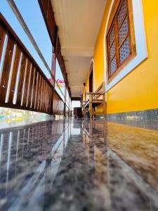 an empty school building with yellow walls and a empty hallway at THE LUXE HOTEL in Puducherry