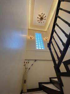 a staircase with a window and a vase in a room at Aral Turkuaz in Cesme