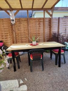 a table with chairs and a potted plant on it at House Viareggio in Viareggio