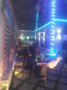 a dining room with tables and chairs and lights at Dee Rocket in Ibadan