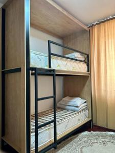 a bunk bed room with two bunk beds in it at Ayla Hostel in Osh