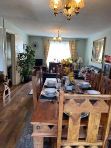 a dining room with a wooden table and chairs at Captivating 2-Bed House in Amesbury Salisbury in Amesbury