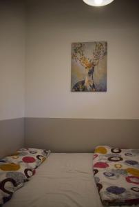 1 dormitorio con 1 cama y una pintura de un ciervo en Helikon 31 Apartman Keszthely, en Keszthely