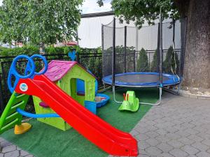 a playground with a slide and a trampoline at Twoja Przestrzeń Noclegi Pokoje Mieszkanie Do Wynajęcia in Nowy Sącz